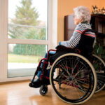 Loneliness senior woman sitting in wheelchair at nursing home