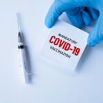 mandatory covid-19 vaccination. medicine, healthcare and pandemic concept. medical mask, syringe vaccine  mutation, mutated new strain of coronavirus SARS-CoV-2 VUI – 202012-01. Covid-2020